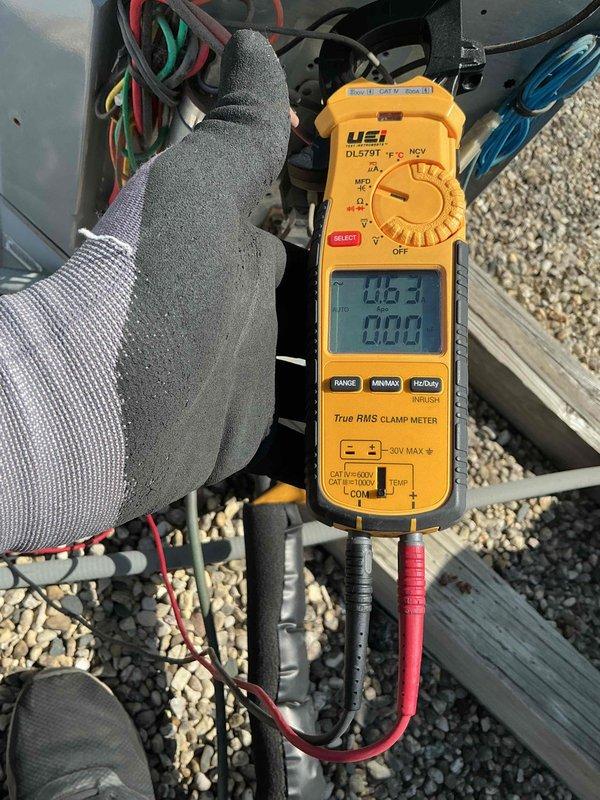Performed comprehensive tune-up and diagnostics on rooftop-mounted air conditioning system. Utilized digital clamp meter to verify electrical readings and system performance, inspecting internal components including capacitors, wiring harnesses, and refrigerant line connections. Customer declined filter replacement as new filter was already installed; all equipment information documented in service tracking system and photographic documentation completed.