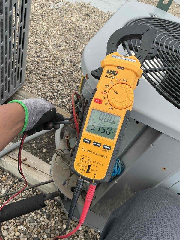 Performed clean and check maintenance on single HVAC system per building specifications. Conducted electrical diagnostics on outdoor condenser unit, recording compressor amperage at 40.4A and supply voltage at 215V using clamp meter. Inspected indoor air handler and verified blower amperage at 12.4A. Customer declined air filter replacement at this time. All equipment operating within normal parameters upon completion of tune-up service.