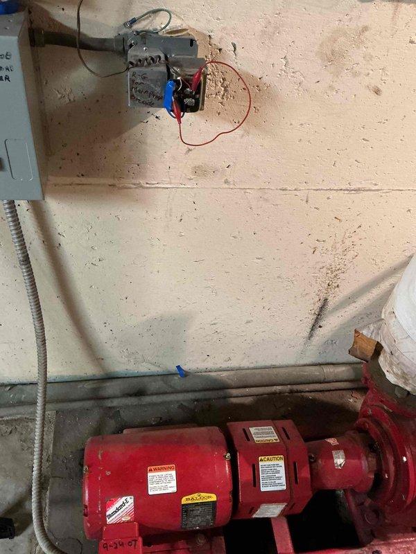Responded to service call regarding unusual noise from boiler pump in main office area. Upon inspection, identified circulator pump assembly exhibiting abnormal operational sounds. Performed diagnostic assessment of pump motor, electrical connections, and relay components. Documented equipment condition with photographs showing pump assembly, associated wiring, and control components for approval process with property management.