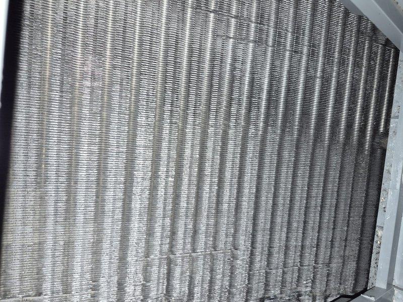 Completed spring clean and check maintenance on air conditioning system per comfort plan agreement. Inspected evaporator coil and found heavy dust and debris accumulation on fins with visible corrosion on copper refrigerant lines. Inspected air filter showing significant dust buildup and discoloration indicating replacement needed. Performed thorough cleaning of evaporator coil assembly, removed dust and lint from fins, checked refrigerant line connections and mounting brackets, and documented system condition with photos. System operational upon completion of maintenance service.