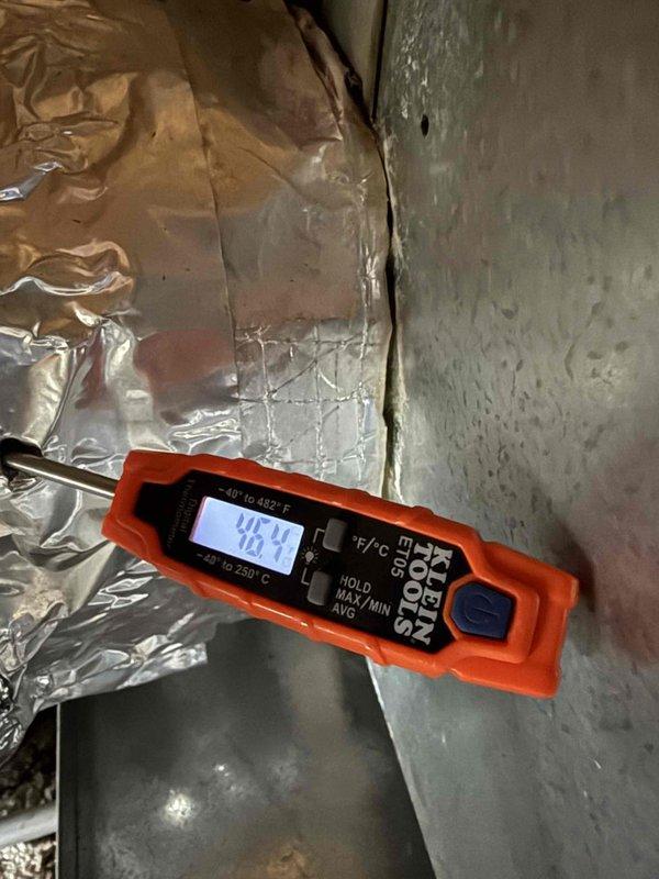 Completed spring maintenance clean and check on air conditioning and air handler combination system per comfort plan guidelines. Performed thorough inspection of refrigerant lines, heat exchanger coil, and electrical connections within the unit compartment, noting normal patina development on copper components. Recorded supply air temperature reading of 79.4°F using digital measurement equipment to verify proper system operation and airflow performance.