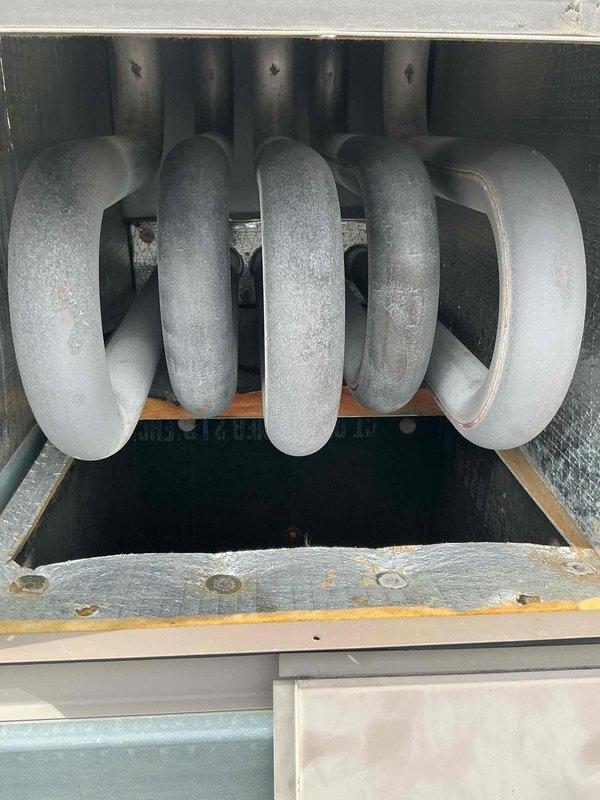 Responded to callback for recurring issue previously addressed. Upon arrival, conducted thorough inspection of HVAC system components including heat exchanger coil assembly and blower motor section. Documented existing conditions showing significant age-related deterioration throughout unit, including heavy rust staining on frame components, corrosion on fasteners, and oxidation on metal surfaces. Photographed serpentine coil configuration and internal electrical components including dual-stack motor, circuit board with wire connections, and blower assembly housing. Collected labor time documentation as required. System exhibits extensive wear consistent with prolonged service life, requiring monitoring for future maintenance needs.
