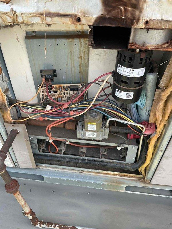 Responded to callback for recurring issue previously addressed. Upon arrival, conducted thorough inspection of HVAC system components including heat exchanger coil assembly and blower motor section. Documented existing conditions showing significant age-related deterioration throughout unit, including heavy rust staining on frame components, corrosion on fasteners, and oxidation on metal surfaces. Photographed serpentine coil configuration and internal electrical components including dual-stack motor, circuit board with wire connections, and blower assembly housing. Collected labor time documentation as required. System exhibits extensive wear consistent with prolonged service life, requiring monitoring for future maintenance needs.