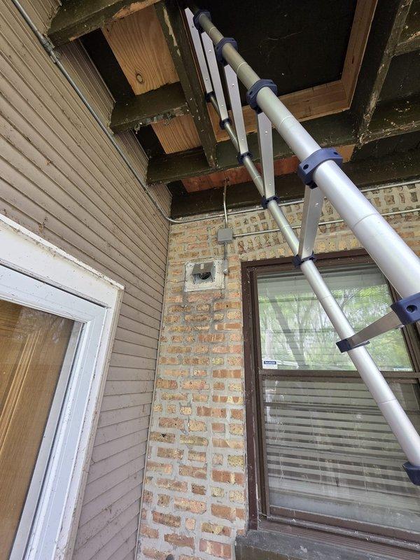 Performed maintenance and diagnostics on two Mitsubishi ductless mini-split systems, approximately 6-10 years old, with one unit serving the kitchen area and the second unit located in the bedroom. Accessed outdoor condenser units using ladder for inspection and service. Verified refrigerant type as R-410A and assessed system charge levels on both units.