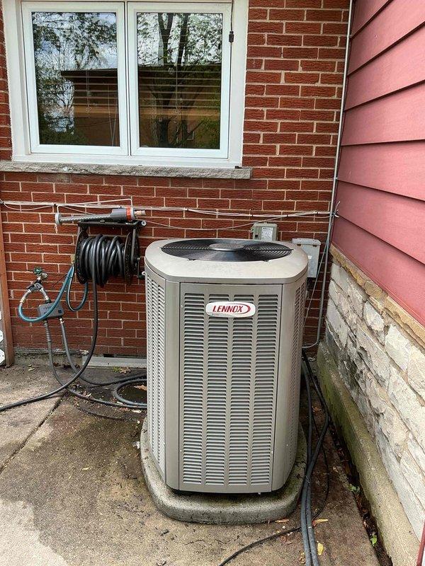 Completed annual air conditioning clean and check maintenance service on Lennox residential condenser unit per comfort plan agreement. Performed comprehensive system inspection including electrical components and capacitor, verified proper operation of all equipment, and documented unit condition with photographs showing outdoor installation and internal electrical compartment.