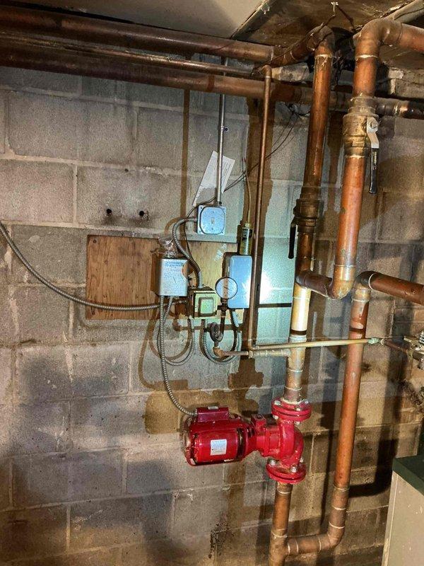 Performed comprehensive walkthrough and operational overview of commercial boiler system with building contact. Reviewed complete heating system configuration including circulator pump operation, timer controls (Model T101B), electrical components, and copper piping distribution network. Explained system functionality, control sequences, and normal operating procedures. Inspected circulator pump, verified proper mounting and connections, and examined timer programming for heating cycles. Assessed electrical junction boxes, conduit installations, and safety controls. Reviewed copper piping system including supply and return lines, connections, and fittings throughout basement mechanical room. Confirmed system was recently serviced with chemical treatment and drain performed in January, requiring no additional maintenance at this time. Provided technical guidance on system operation and answered questions regarding heating controls and distribution.
