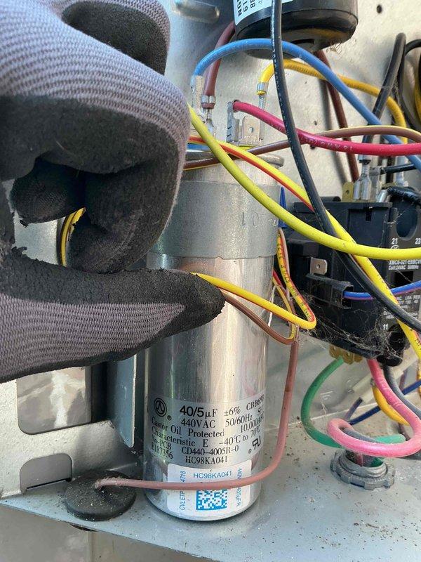 Completed spring preventative maintenance on air conditioning system per comfort plan agreement. Performed comprehensive clean and check including inspection of electrical components, tested capacitor specifications (40/5μf, 440VAC), verified all wire connections secure, and measured system amperage at 0.00A with 60.75Hz frequency reading. All components operating within normal parameters.
