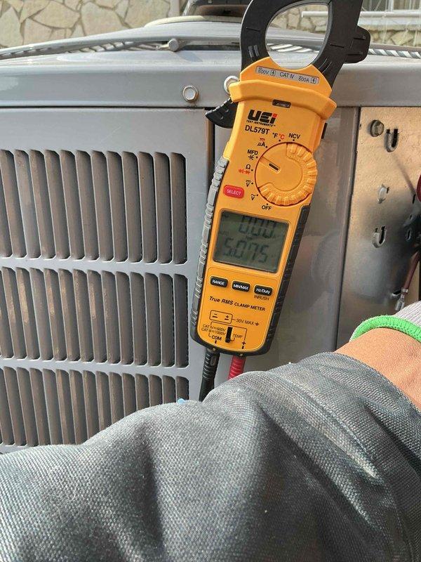 Completed spring preventative maintenance on air conditioning system per comfort plan agreement. Performed comprehensive clean and check including inspection of electrical components, tested capacitor specifications (40/5μf, 440VAC), verified all wire connections secure, and measured system amperage at 0.00A with 60.75Hz frequency reading. All components operating within normal parameters.