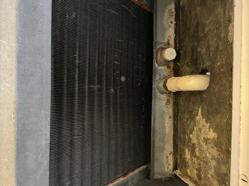 Completed preventative maintenance tune-up on single HVAC system for new customer. Performed standard inspection of air handler and condensing unit, checked refrigerant levels, cleaned coils, inspected ductwork connections, and verified proper system operation. Documentation photos captured showing evaporator coil assembly with visible aging on surrounding infrastructure and air handler ductwork components in mechanical space.