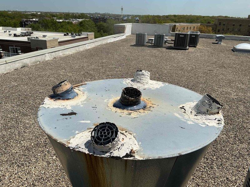 Responded to rooftop service call to address loose and deteriorating boiler flue pipe connections. Upon inspection, found three flue penetrations with compromised weatherproofing, extensive rust staining around mounting points, and degraded sealant material allowing potential water infiltration and exhaust gas leakage. Resecured all flue pipe connections, cleaned rust deposits from affected areas, and applied fresh weatherproof sealant around all penetration points to restore proper seal integrity. Verified all vent caps were properly seated and secured to prevent future displacement. System tested and confirmed proper draft operation with no exhaust leaks detected.