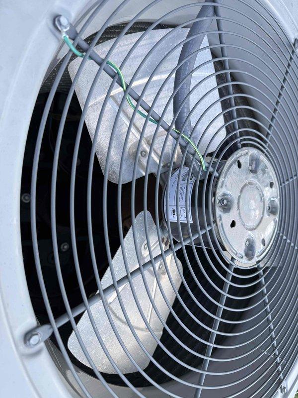 Replaced defective condenser fan motor under warranty on HVAC unit. Removed failed motor assembly, wire guard, and fan blade from outdoor condensing unit. Installed new motor, reassembled components, and verified proper operation before returning to office for warranty claim processing.