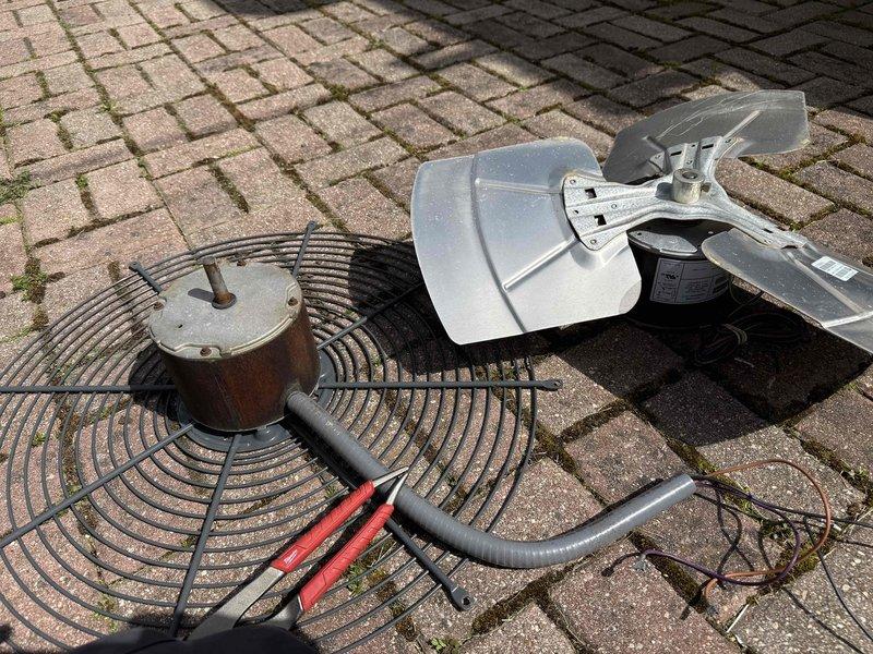 Replaced defective condenser fan motor under warranty on HVAC unit. Removed failed motor assembly, wire guard, and fan blade from outdoor condensing unit. Installed new motor, reassembled components, and verified proper operation before returning to office for warranty claim processing.