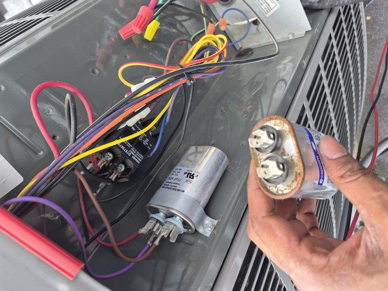 Responded to commercial facility for multiple HVAC equipment failures. Diagnosed and replaced four failed capacitors across multiple systems: dual run capacitor (45+5 MFD) on second floor classroom compressor unit, blower capacitor on twin furnace right-hand unit, 7.5 MFD capacitor on rear rooftop AC unit, and 7.5 MFD blower capacitor on second floor classroom air handler. All capacitors tested out of acceptable range and showed visible signs of corrosion and deterioration. Cleaned blower fan on twin furnace unit as needed. Verified proper operation of all systems following component replacement. All units restored to normal operating condition.