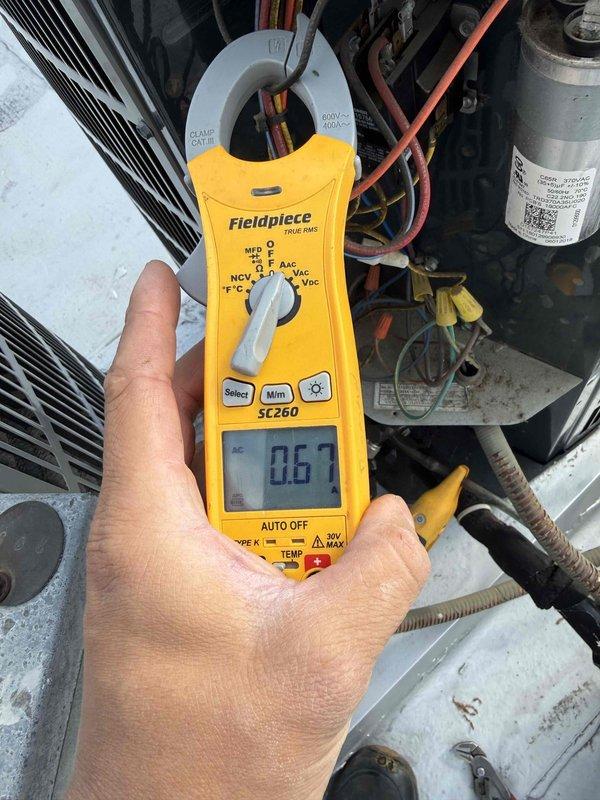 Completed comprehensive tune-up maintenance on single-system air conditioning and air handler unit. Performed electrical diagnostics using clamp meter to verify amperage draws and system performance, measuring compressor current at 25.0 amps and additional circuit readings at 0.67 amps to ensure proper operation. Inspected capacitor, electrical connections, and wiring integrity; replaced air filter as part of standard maintenance protocol to optimize airflow and system efficiency.