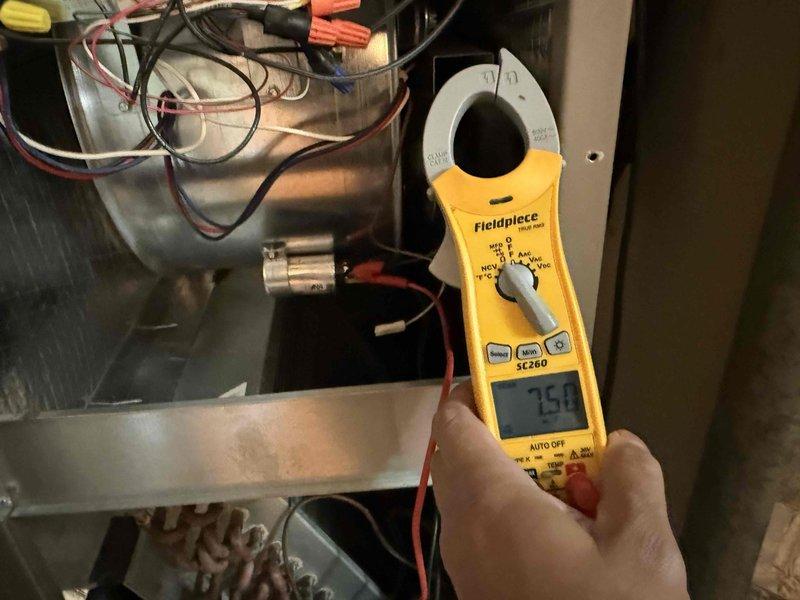 Completed comprehensive tune-up maintenance on single-system air conditioning and air handler unit. Performed electrical diagnostics using clamp meter to verify amperage draws and system performance, measuring compressor current at 25.0 amps and additional circuit readings at 0.67 amps to ensure proper operation. Inspected capacitor, electrical connections, and wiring integrity; replaced air filter as part of standard maintenance protocol to optimize airflow and system efficiency.