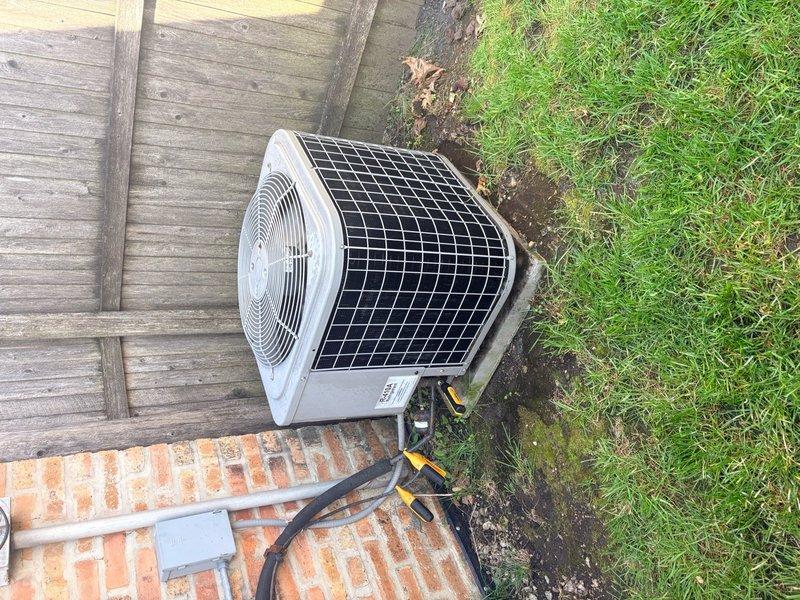 Completed annual air conditioning clean and check per comfort plan agreement on single system. Performed comprehensive maintenance including inspection of outdoor condenser unit, verified electrical connections and components, cleaned coils and removed debris accumulation including cobwebs from electrical terminals and wiring. All wiring connections found secure despite weathering; unit operating within normal parameters upon completion of service.