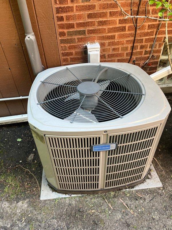 Completed air conditioning replacement estimate for 11-year-old residential cooling system that had required refrigerant recharge the previous year. Evaluated existing outdoor condenser unit positioned on concrete pad against brick wall with electrical disconnect and condensate drainage in place. Discussed replacement options for aging AC system while noting that existing 3-year-old furnace remains serviceable, and addressed customer's ongoing concern regarding intermittent furnace noise that occurs when air conditioning operates, recommending further diagnostic evaluation if issue persists after AC replacement.