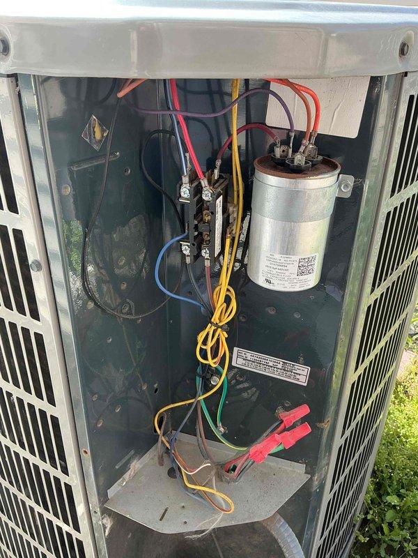 Completed annual Comfort Plan maintenance on single HVAC system including clean and check procedures on outdoor condensing unit and indoor air handler. Inspected electrical components, capacitor, contactor assembly, and wiring connections in outdoor unit with access panel removed; all components found in serviceable condition with proper terminations. Replaced indoor air filter with new blue media filter in cardboard frame. Verified system operation and confirmed all equipment functioning within normal parameters for continued comfort plan coverage.