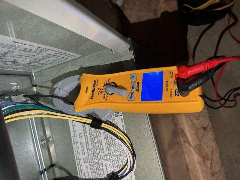 Completed spring clean and check maintenance service on two air conditioning systems per the comfort plan agreement. Performed comprehensive inspection of both units including electrical testing with digital multimeter to verify proper voltage and amperage readings. Inspected and tested dual-run capacitor and contactor on first floor system, confirmed all electrical connections secure and within manufacturer specifications. Documented equipment condition with photos showing internal components and diagnostic equipment in use during testing procedures.