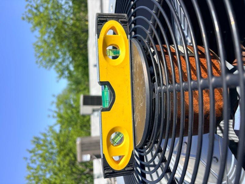 Installed vibration isolation pads under the outdoor condensing unit to reduce noise and equipment vibration transmission to the structure. Verified unit was properly leveled after installation using a precision level tool to ensure optimal compressor operation and system performance.