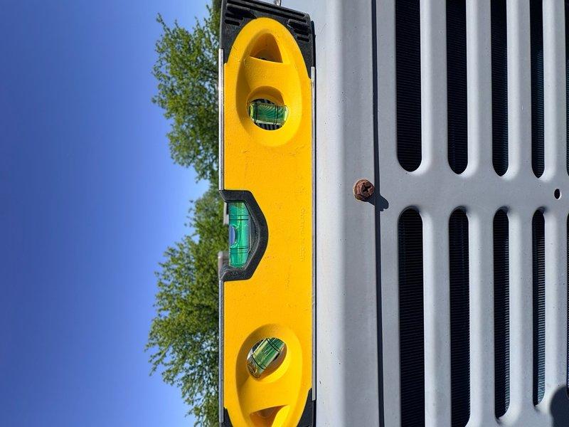 Installed vibration isolation pads under the outdoor condensing unit to reduce noise and equipment vibration transmission to the structure. Verified unit was properly leveled after installation using a precision level tool to ensure optimal compressor operation and system performance.