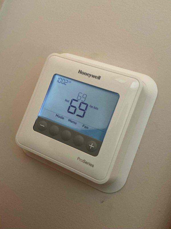 Completed comprehensive clean and check maintenance service on ClimateMaster heat pump system, model TRM18G1SSCSB. Inspected and verified proper operation of all system components, checked refrigerant levels, tested electrical connections, and confirmed thermostat functionality with Honeywell ProSeries unit displaying proper heating mode operation at 69°F. Replaced air filter and documented service date on filter frame for future reference.