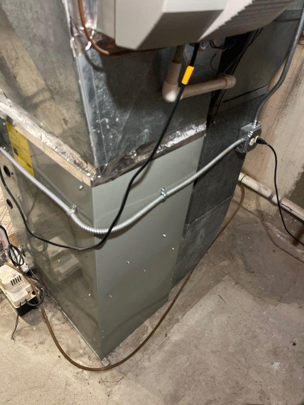 Responded to service call for reported furnace leak in residential property. Upon arrival, conducted thorough inspection of gray cabinet furnace unit located in basement utility space. Evaluated condensate drainage system, PVC piping, refrigerant lines, and all visible connections for signs of moisture or active leaking. Examined flexible ductwork, copper refrigerant lines, and condensate pump installation. Assessed overall system condition and documented equipment with photos. Provided comprehensive estimate for complete HVAC system replacement based on findings and customer's need for reliable heating solution prior to extended absence from property.