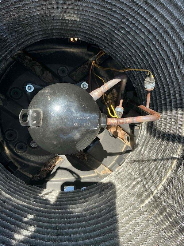 Completed warranty compressor replacement on HVAC system. Removed failed compressor from outdoor unit, verified proper refrigerant recovery, and installed replacement compressor with new accumulator. Conducted system pressure testing using digital manifold gauges, confirmed proper high and low side pressures, and verified all copper line connections were secure. Tagged defective compressor for warranty processing and shop return.