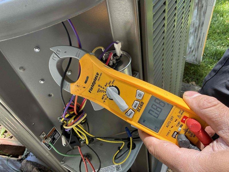 Completed scheduled maintenance callback on residential HVAC system. Performed electrical diagnostics on outdoor condensing unit using multimeter to verify proper voltage and component functionality. Tested capacitor connections and confirmed all wire terminations were secure. Inspected indoor furnace unit in basement, including PVC condensate drain lines, refrigerant line connections, and electrical control panel. All components operating within normal parameters with no deficiencies noted. System tested and left in proper working condition.