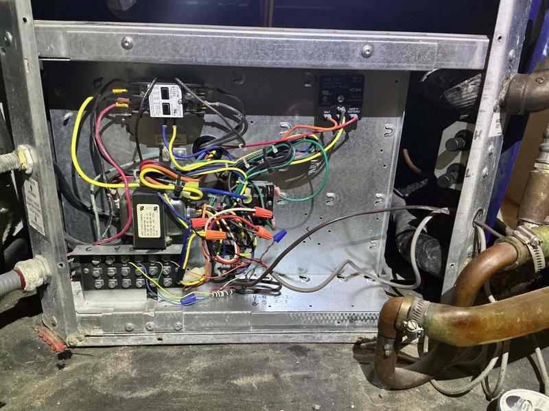 Completed Comfort Plan clean and check maintenance service on heat pump system. Performed comprehensive inspection of electrical control panel, verifying all wire connections, terminal blocks, and relay components for proper operation and secure mounting. Inspected blower motor assembly and associated HVAC refrigerant lines with mounting clamps. Confirmed Nest thermostat functioning correctly with heat mode set to 67°F and proper communication with system controls.