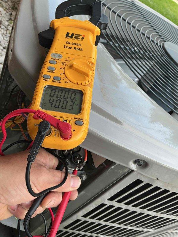 Performed comprehensive clean and check maintenance on residential air conditioning system and air scrubber unit per Comfort Plan agreement. Conducted electrical diagnostics on outdoor condenser unit using digital multimeter, verifying amperage draw and voltage readings at 408V to ensure proper compressor and fan motor operation. Inspected condenser coil fins, confirming clean condition and adequate airflow. Accessed indoor air handler, inspected blower motor assembly, circuit boards, and electrical connections for proper operation. Verified all wiring connections secure and system components functioning within manufacturer specifications.