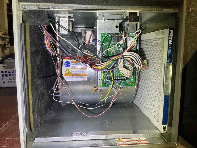 Performed comprehensive clean and check maintenance on residential air conditioning system and air scrubber unit per Comfort Plan agreement. Conducted electrical diagnostics on outdoor condenser unit using digital multimeter, verifying amperage draw and voltage readings at 408V to ensure proper compressor and fan motor operation. Inspected condenser coil fins, confirming clean condition and adequate airflow. Accessed indoor air handler, inspected blower motor assembly, circuit boards, and electrical connections for proper operation. Verified all wiring connections secure and system components functioning within manufacturer specifications.