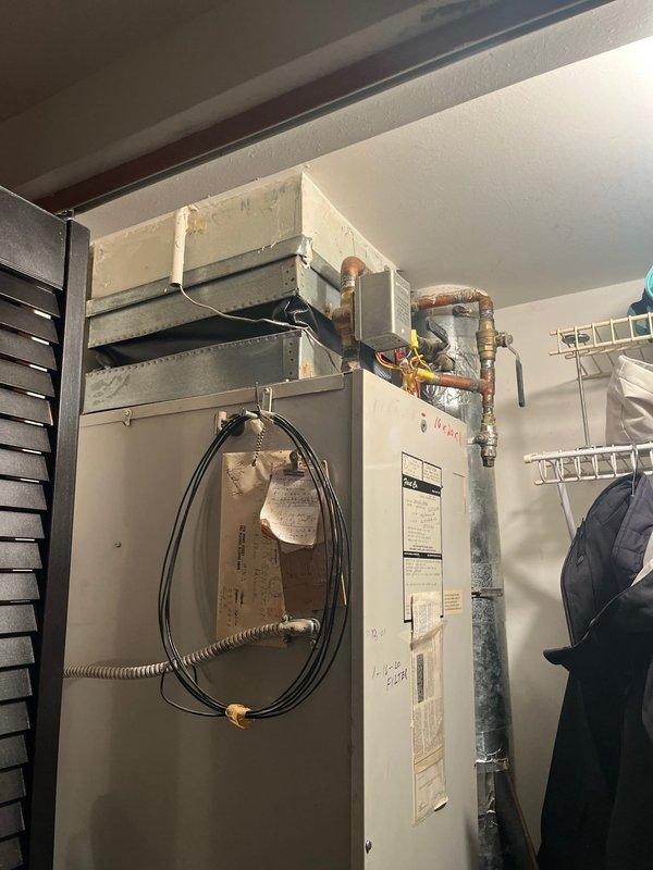 Responded to service call for air conditioning system that had lost cooling capacity over the past month and subsequently experienced complete system shutdown including thermostat failure. Accessed rooftop-mounted HVAC unit via interior ladder and hatch to perform comprehensive system evaluation. Upon inspection, determined that the aging equipment had reached end of serviceable life and recommended full system replacement rather than repair due to the extent of component failure and age of the existing unit.