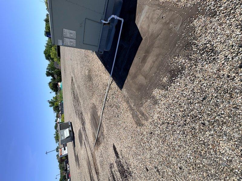 Responded to callback for recurring noise complaint on rooftop HVAC unit. Accessed roof-mounted package unit during dry weather conditions as requested. Performed visual inspection of unit exterior, cabinet panels, and mounting hardware. Documented equipment condition with photographs showing gray cabinet-style RTU positioned on gravel pad with electrical conduit connections. Unit appeared secure on pad with no visible loose components or damaged panels during static inspection. Unable to replicate noise condition at time of visit. Recommend monitoring unit during operation and scheduling follow-up visit when noise is actively occurring to properly diagnose source of intermittent sound.