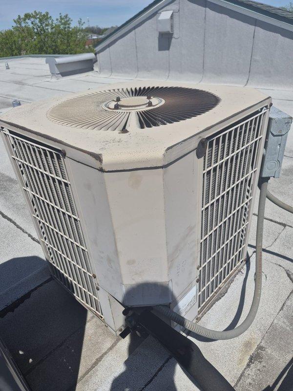 Completed preventative maintenance tune-up on rooftop HVAC system with R22 refrigerant. Inspected aging equipment and identified multiple components showing wear including capacitor with visible corrosion and discoloration, contactor, blower wheel, heating coil, and evaporated coil with rust and blockage. System operational at time of service; customer declined filter replacement and requested no filter installation. Equipment information verified and updated in service records.
