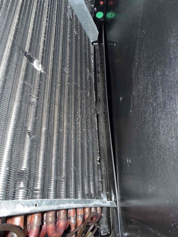 Performed comprehensive tune-up on single-system HVAC unit. Inspected blower assembly and evaporator coil, noting dust accumulation on fan motor and blades requiring attention during routine maintenance. Verified operational status of control board with LED indicators functioning properly, confirmed refrigerant lines intact with normal patina, and replaced air filter. All components inspected and system operating within normal parameters.