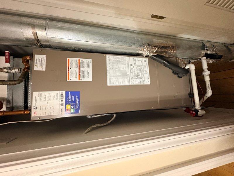 Completed preventive maintenance tune-up on residential split system air conditioning unit with horizontal air handler installation. Performed comprehensive system inspection including refrigerant line connections, electrical components, condensate drain operation, and ductwork integrity in confined mechanical space. Replaced 12x20x1 air filter and verified all safety labels and system components were clean and operational.