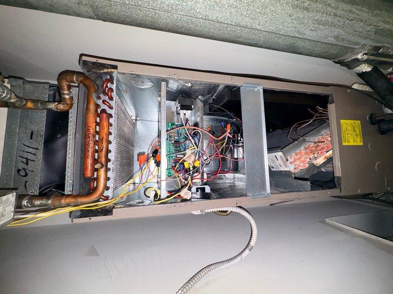 Completed comprehensive spring tune-up and clean-and-check service on single-zone HVAC system consisting of attic-mounted air handler with evaporator coil and rooftop condensing unit. Performed thorough inspection of air handler components including refrigerant lines, evaporator coil, electrical connections, control board, auxiliary heat elements, and condensate drainage system. Inspected outdoor condensing unit including fan motor operation, condenser coil condition, and refrigerant line connections. Verified all electrical connections secure, tested system operation through complete cooling cycle, and confirmed proper airflow and temperature differential across evaporator coil. System operating within manufacturer specifications at time of service completion.