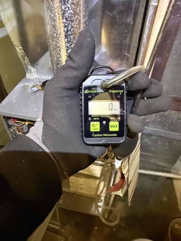 Responded to emergency gas leak service call at Suite #31 after utility company detected leak and shut off gas supply. Upon arrival, located and repaired gas leak on furnace supply line. Performed comprehensive furnace inspection including combustion analysis, ignition system verification, delayed ignition timing check, and venting system assessment. Conducted carbon monoxide testing throughout mechanical space with calibrated digital meter, confirming safe levels after repairs. Identified code violations noted by fire department inspection: furnace access doors require corrugated construction for proper code compliance, and gas meter shut-off valve currently concealed behind wall above sink lacks required emergency accessibility. Documented existing conditions with photos showing gas piping configuration, shut-off valve location, and surrounding HVAC components. Recommended opening wall section and installing accessible cabinet door to provide code-compliant access to gas shut-off val