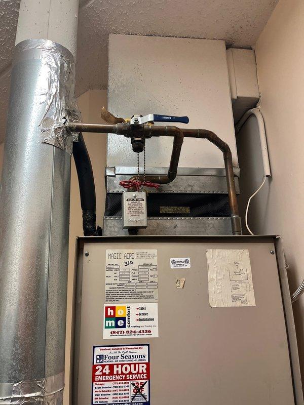 Completed comprehensive evaluation of existing Magic Aire air handler and associated air conditioning system for replacement estimate. Documented current equipment condition through detailed photography, noting aging ductwork with surface oxidation, existing refrigerant lines with ball valve assembly, and evaporator coil housing. System assessment included inspection of condensate drainage, electrical connections, filter accessibility, and overall installation configuration within confined mechanical space to determine replacement specifications and requirements.