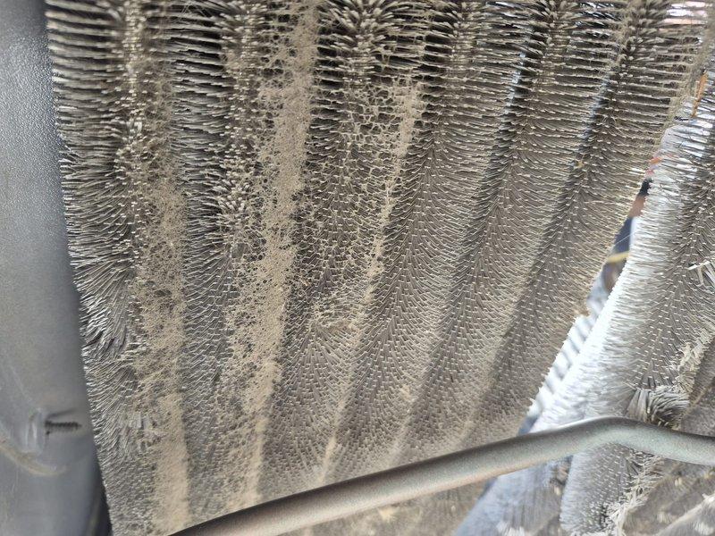 Completed annual Comfort Plan maintenance on air conditioning and air handler system. Performed comprehensive clean and check service including inspection of evaporator coils, which showed moderate dust and debris accumulation on fin surfaces. Cleaned coils to restore optimal airflow and heat transfer efficiency. Inspected heat exchanger and internal components, verified proper operation of all mechanical systems, and confirmed refrigerant lines were secure and properly insulated. Additionally, provided customer assistance with adjusting water temperature settings on IBC 90% efficient boiler system per request.