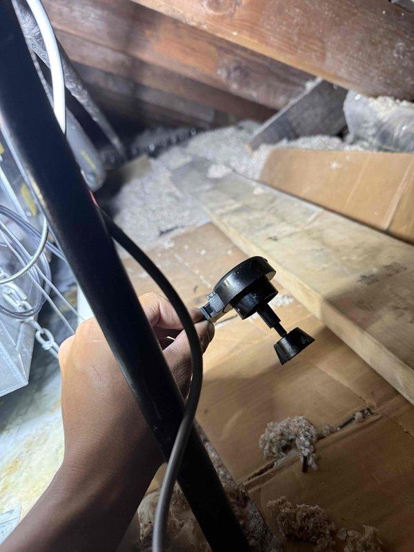 Responded to no-cooling call on one-year-old AC system originally installed by our company. Performed diagnostic inspection in attic space, examining condensate drain system and evaporator coil assembly. Found evidence of moisture accumulation and oxidation on ductwork components, indicating potential drainage issues. Conducted thorough system assessment using diagnostic equipment to identify root cause of unit failure. Documented equipment condition with photos showing insulated ductwork, condensate chain assembly, and mechanical components. Completed warranty service inspection and collected continuation of labor time from previous CNC work performed earlier in the month.