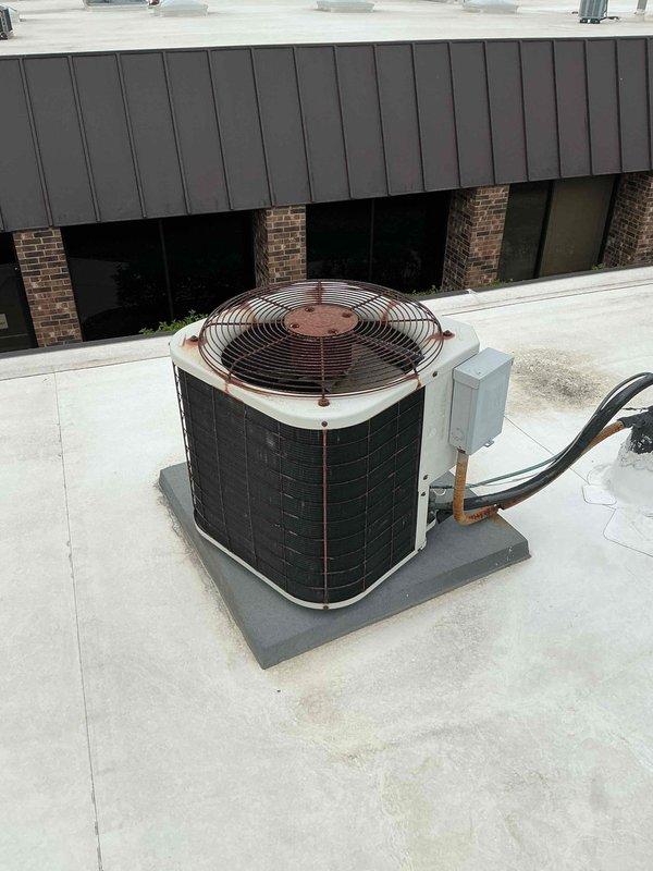 Replaced 3-ton air conditioning condenser unit serving the rear area of a commercial building. The new outdoor condenser was installed on the existing rooftop concrete pad with proper electrical disconnect and refrigerant line connections completed.