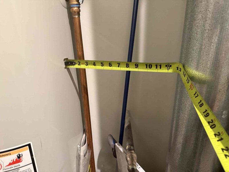 Responded to service call for reported water leak potentially related to furnace malfunction indicated by green flashing light. Upon inspection, discovered water heater with severe corrosion and rust damage on top surface, particularly around access port area, indicating long-term moisture exposure and deterioration. Documented extensive paint failure and metal oxidation throughout unit. Assessed furnace status and noted previous history of cracked heat exchanger from prior service visit. Performed diagnostic evaluation of both water heater and heating system to determine source of leak and potential safety concerns. Measured and photographed affected areas showing moisture accumulation on nearby insulation. Recommended comprehensive evaluation by senior technician before proceeding with any repairs given safety implications and equipment condition.
