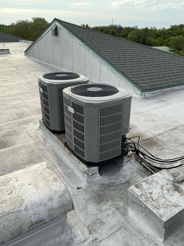 Responded to warranty call for system with refrigerant restriction. Upon arrival, diagnosed suction side pressure running very low with high side pressure increasing normally during charging attempt, indicating blockage in refrigerant circuit. Performed refrigerant recovery and system evaluation. Pulled refrigerant into compressor, inspected piston for obstruction, and flushed refrigerant lines to clear restriction. Verified proper refrigerant flow through both suction and discharge sides of system. Recharged system to manufacturer specifications and confirmed normal operating pressures and temperatures on both rooftop condenser units.