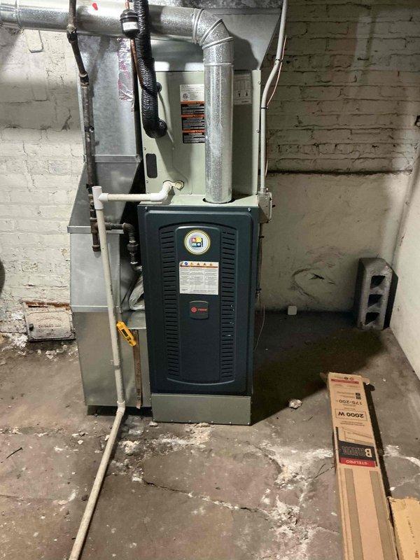 Responded to no-power complaint on residential air conditioning system. Upon arrival, found unit completely non-responsive with no power supply to outdoor condenser. Performed diagnostic testing and traced electrical circuit from thermostat through furnace control board to outdoor disconnect. Measured temperature readings at equipment location showing 71.7°F ambient temperature in mechanical room. Documented existing HVAC installation including furnace unit and associated ductwork in basement location. Collected equipment model and serial number information for service records. Presented flat rate repair options to restore cooling operation and discussed preventive maintenance program enrollment. Additional diagnostic time required beyond initial service call to isolate root cause of electrical failure.