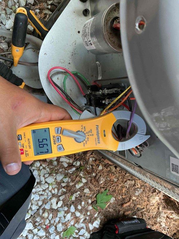 Completed thorough clean and check maintenance on air conditioning system per comfort plan agreement. Performed comprehensive electrical diagnostics including capacitor testing with digital multimeter, verifying proper capacitance values and voltage readings on dual-run capacitor (45+5μF, 440VAC). Inspected all electrical connections, contactor operation, and system components, confirming equipment is operating within manufacturer specifications and ready for continued service.