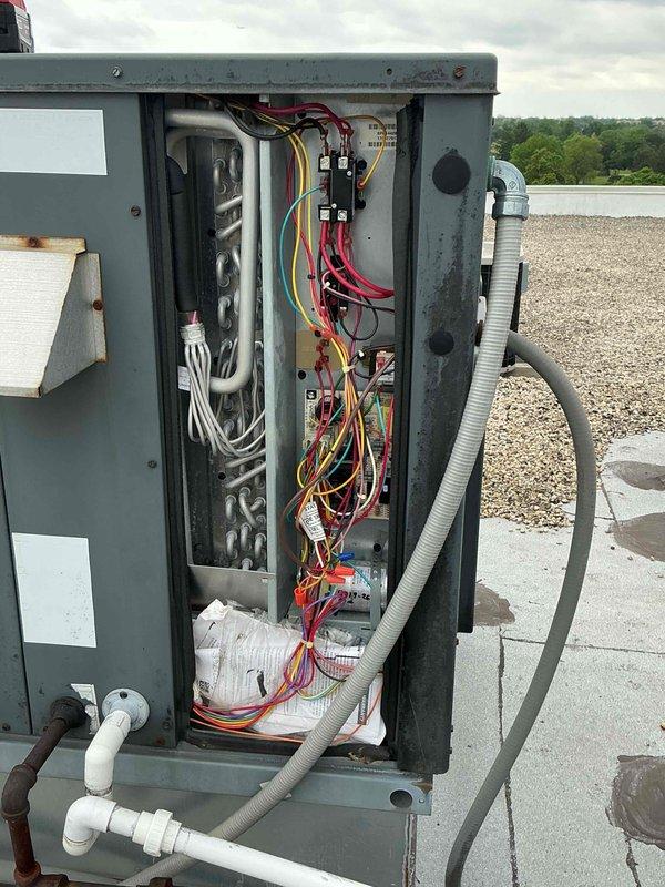 # Replace Capacitor and Contactor for West RTU

Responded to service call for non-operational rooftop package unit on commercial facility. Upon arrival, accessed the west RTU and performed diagnostic evaluation of electrical components. Testing revealed failed capacitor and contactor preventing compressor operation.

Opened electrical control panel and disconnected power at the rooftop disconnect switch. Removed defective dual-run capacitor and single-pole contactor from control circuit. Verified proper voltage supply and checked all wire connections for integrity. Installed new OEM-equivalent capacitor with correct microfarad rating for compressor and condenser fan motor. Replaced contactor with appropriate amperage-rated component to handle compressor load.

Reconnected all electrical terminations following proper color coding and secured wiring within panel enclosure. Restored power and cycled unit through complete operational sequence. Verified compressor startup, confirmed proper 