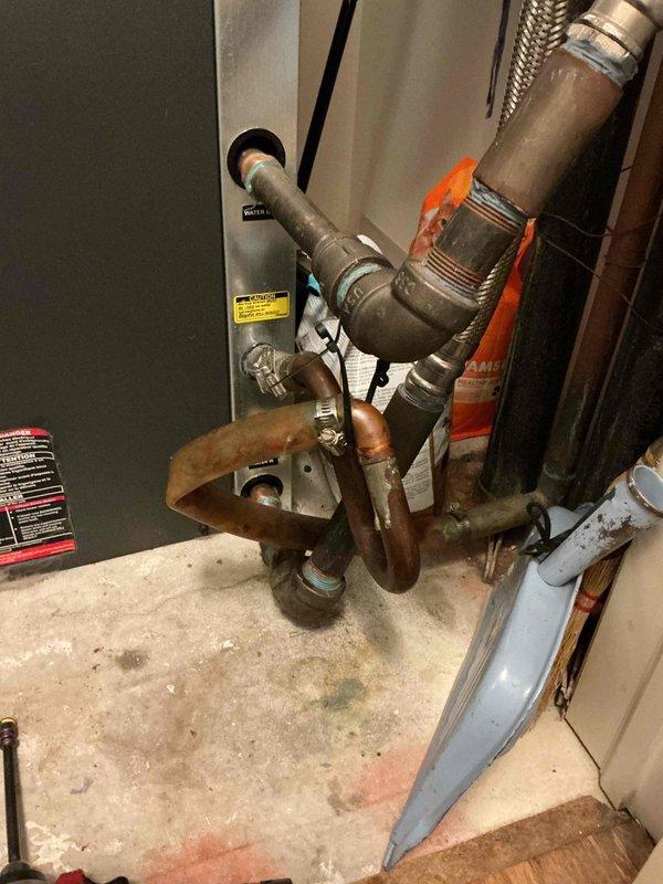 Responded to no cooling complaint on HVAC system less than 10 years old. Upon arrival, verified thermostat settings, checked filter condition, and confirmed breaker status. Performed system diagnostics and temperature measurements, recording supply air temperature of 56.5°F at the air handler unit. Inspected refrigerant lines showing oxidation and discoloration on copper piping, examined condensate drainage system, and evaluated overall equipment condition. Noted damaged insulation material on air handler cabinet requiring attention. Documented equipment information and captured photographic evidence of system components including piping connections, heat tape applications, and mechanical room configuration for service records.