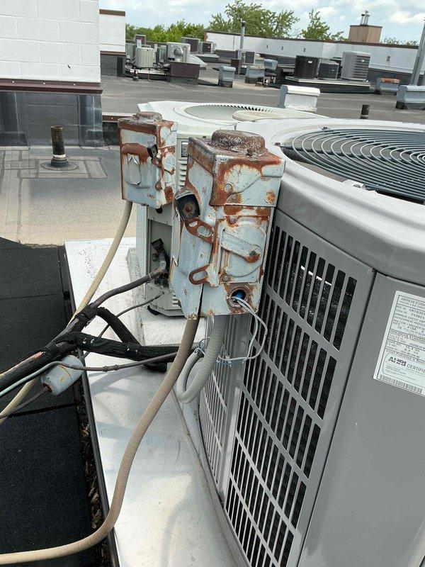 Responded to commercial rooftop HVAC system requiring electrical component replacement. Removed and replaced severely corroded electrical disconnect box that exhibited extensive rust damage and oxidation, which posed both safety and operational risks to the condensing unit. Installed new surge protector to provide electrical protection against voltage spikes and power fluctuations. All electrical connections were properly terminated and secured according to manufacturer specifications and NEC requirements. System tested and verified operational upon completion.